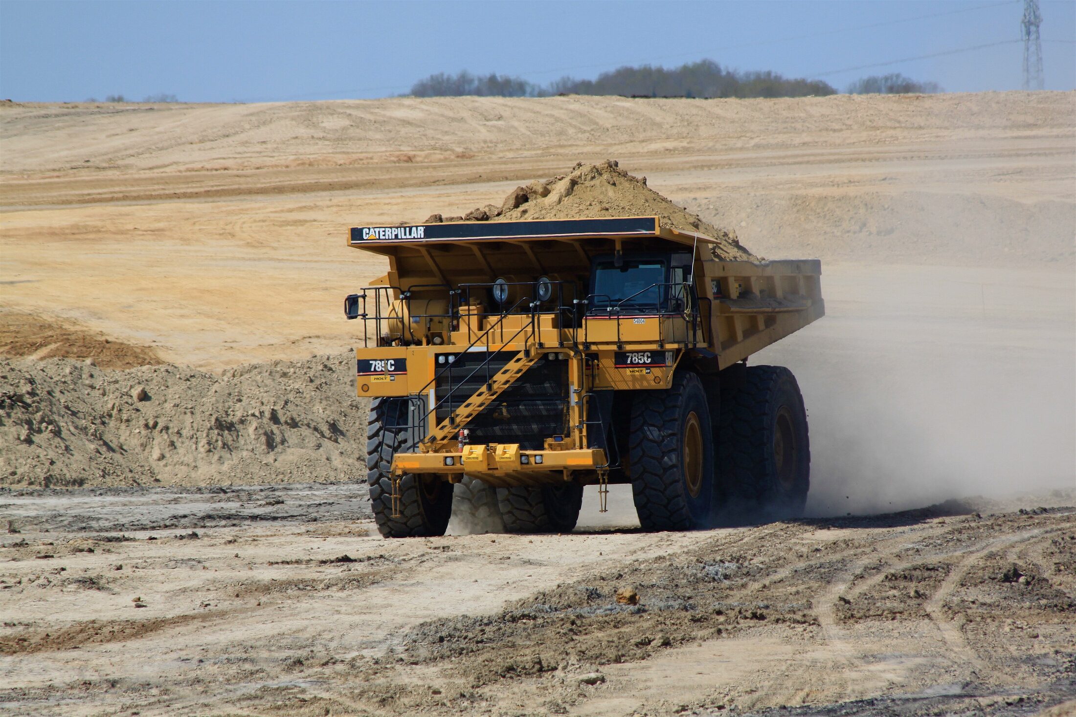 Loaded haul truck moving ore on a mine haul road